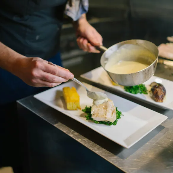 Restaurant chef preparing dinner for guests